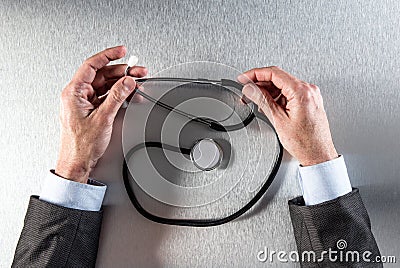 Doctor hands in reflection holding a stethoscope for clinical treatment Stock Photo