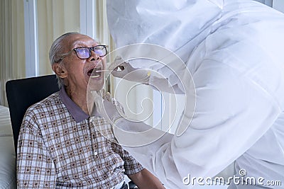 Doctor in hazmat suit doing swab test Stock Photo