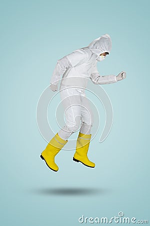 Doctor in hazmat suit running in studio Stock Photo