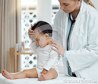 Doctor is highly concerned about the little ones wellbeing. a paediatrician examining a baby in a clinic. Stock Photo