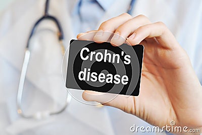 Doctor holding a paper card with text Crohn`s disease, medical concept Stock Photo