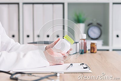 Doctor holding bottle of dietary supplement Stock Photo