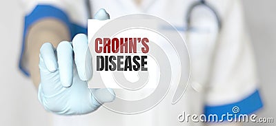 Doctor holding a card with text Crohn disease, medical concept Stock Photo