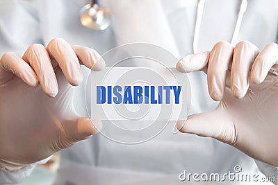 Doctor holding a card with text DISABILITY Stock Photo