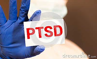 Doctor holding a card with text PTSD medical concept Stock Photo