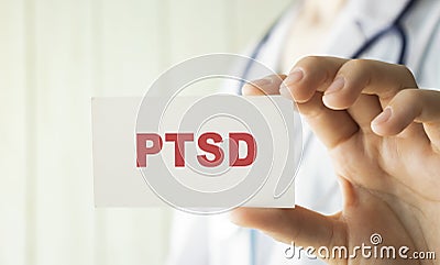 Doctor holding a card with text PTSD medical Stock Photo