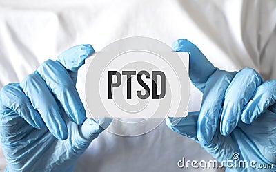 Doctor holding a card with text ptsd, medical concept Stock Photo