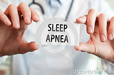 Doctor holding a card with text SLEEP APNEA Stock Photo