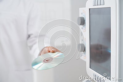 Doctor holding CD plate with results after ultrasound. Stock Photo