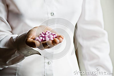 A doctor holding a handful of vitamin supplement Stock Photo