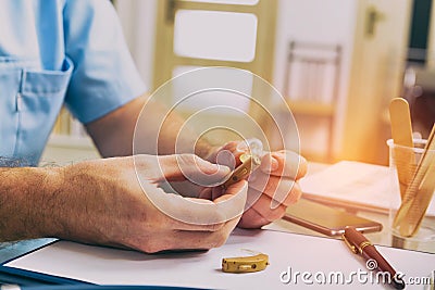 Doctor holding hearing aid Stock Photo