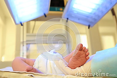 Doctor holding newborn child`s foot in hospital Stock Photo