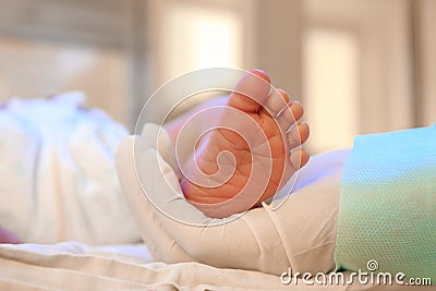 Doctor holding newborn child`s foot in hospital Stock Photo