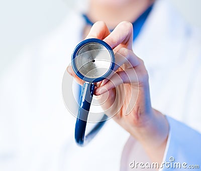 Doctor holding out stethescope Stock Photo