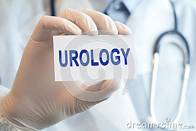 Doctor holding a paper card with text UROLOGY, medical concept Stock Photo