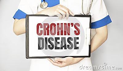 Doctor holding a paper plate with text Crohn disease, medical concept Stock Photo