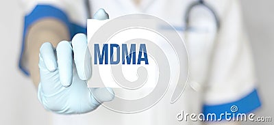 Doctor holding a paper plate with text MDMA, medical concept Stock Photo