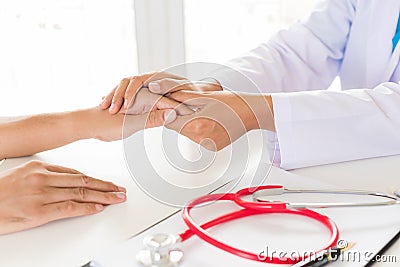 Doctor holding patient`s hand. Medicine and health care concept. Stock Photo