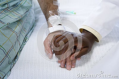 Doctor holding patients hand Stock Photo