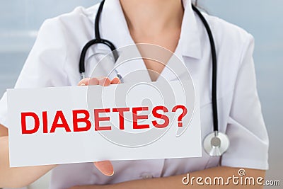 Doctor holding placard with diabetes text Stock Photo