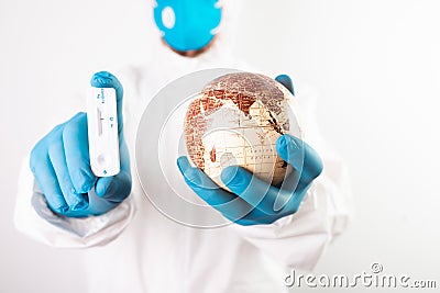 Doctor holding the planet Earth and coronavirus test Stock Photo