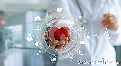 Doctor holding red heart shape in hand and icon medical Stock Photo