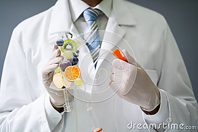 Doctor Holding Saline Bag With Fruit Slices Inside In Hospital Stock Photo