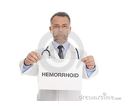 Doctor holding sign with word HEMORRHOID Stock Photo