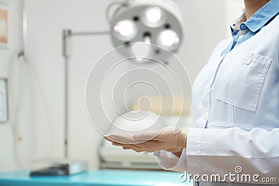 Doctor holding silicone implant for breast augmentation in clinic, closeup Stock Photo