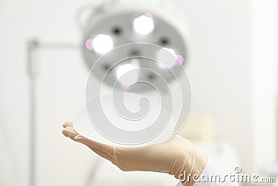 Doctor holding silicone implant for breast augmentation in clinic, closeup with space for text Stock Photo
