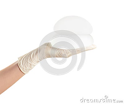 Doctor holding silicone implants for breast augmentation on white background. Stock Photo