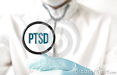 Doctor holding a stethoscope with text PTSD, medical concept Stock Photo