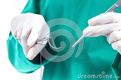 Doctor holding surgical forceps suture needle, suturing material Stock Photo