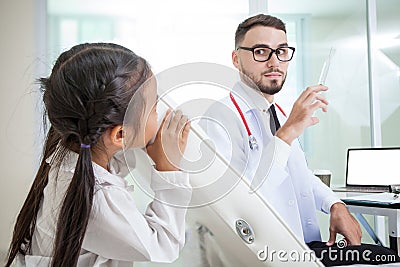 doctor holding a syringe needle with injection vaccination. girl Stock Photo