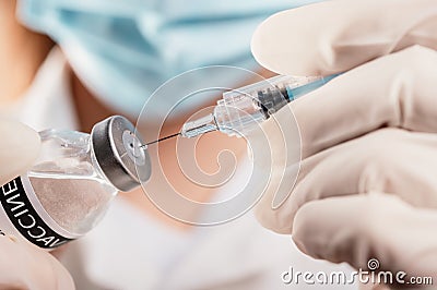 Doctor holding a syringe with a single bottle vial of Covid-19 vaccine for children or adults. Concept fight against virus. Close Stock Photo