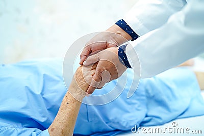 Doctor holding touching hands Asian senior or elderly old lady woman patient with love, care, helping, encourage and empathy. Stock Photo