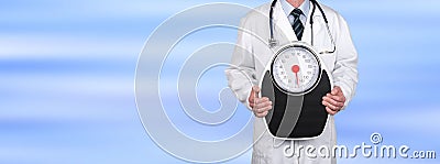 Doctor holding a weight scale Stock Photo