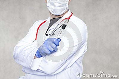 The doctor holds the ampoule to be tested for coronavirus Stock Photo