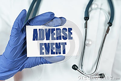 The doctor holds a business card that says - ADVERSE EVENT Stock Photo