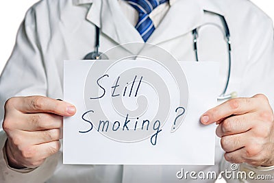 Doctor holds a clipboard with still smoking label Stock Photo