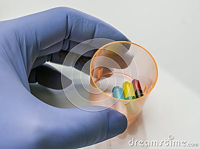 Doctor holds glass with medication for palliative care Stock Photo
