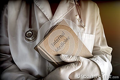 Doctor holds in an internal medicine book in a hospital Stock Photo