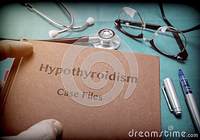Doctor holds in its hands a book on the Hypothyroidism Stock Photo