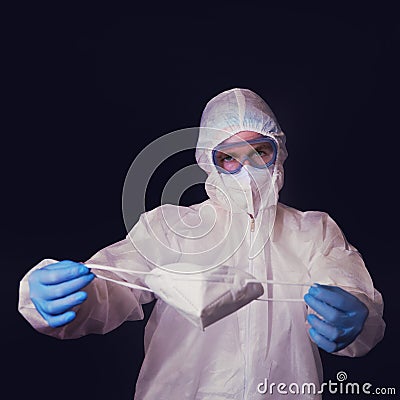 The doctor holds a medical mask - respirator n95 ffp2, black background Stock Photo