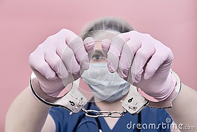 The doctor holds out his handcuffed hands. Call stay home for people Stock Photo