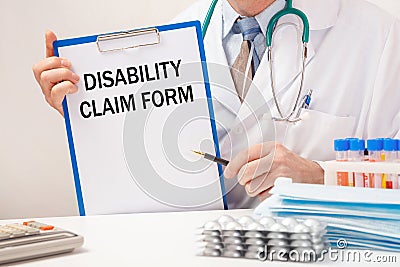 Doctor holds paper with inscription Disability Claim Form Stock Photo