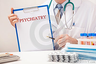 Doctor holds paper with inscription PSYCHIATRY Stock Photo