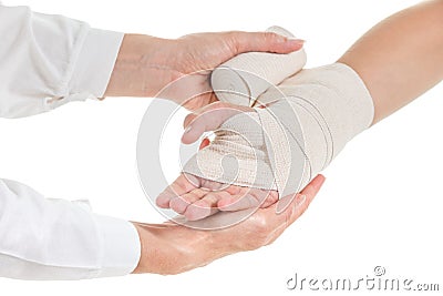 Doctor imposes an elastic bandage to the patient's hand Stock Photo