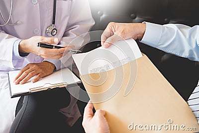 Doctor informing patient`s of diagnosis medical record from paper in hospital Stock Photo