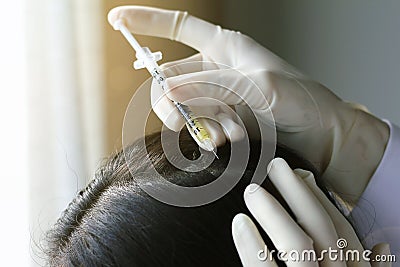 Doctor injecting at patient`s hair and scalp, Close up shot of Dermatologist exam scalp disorder. Stock Photo